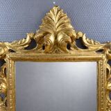 Antique Louis XV style mirror in gilded carved wood.