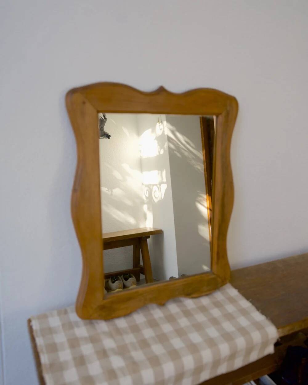 Wooden mirror with a shaped frame