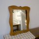 Wooden mirror with a shaped frame