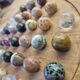 Wooden solitaire game with semi-precious stones