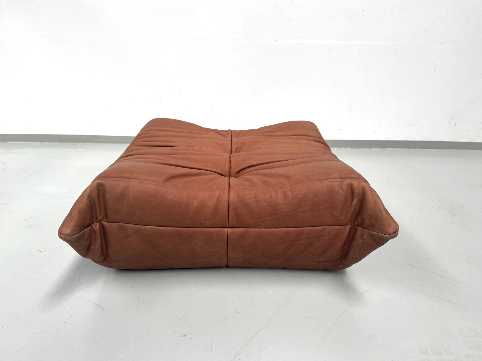 French Togo ottoman in cognac neck leather attributed to Michel Ducaroy for Ligne Roset