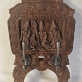 Coat rack with 2 hooks on a frieze of divinities in teak