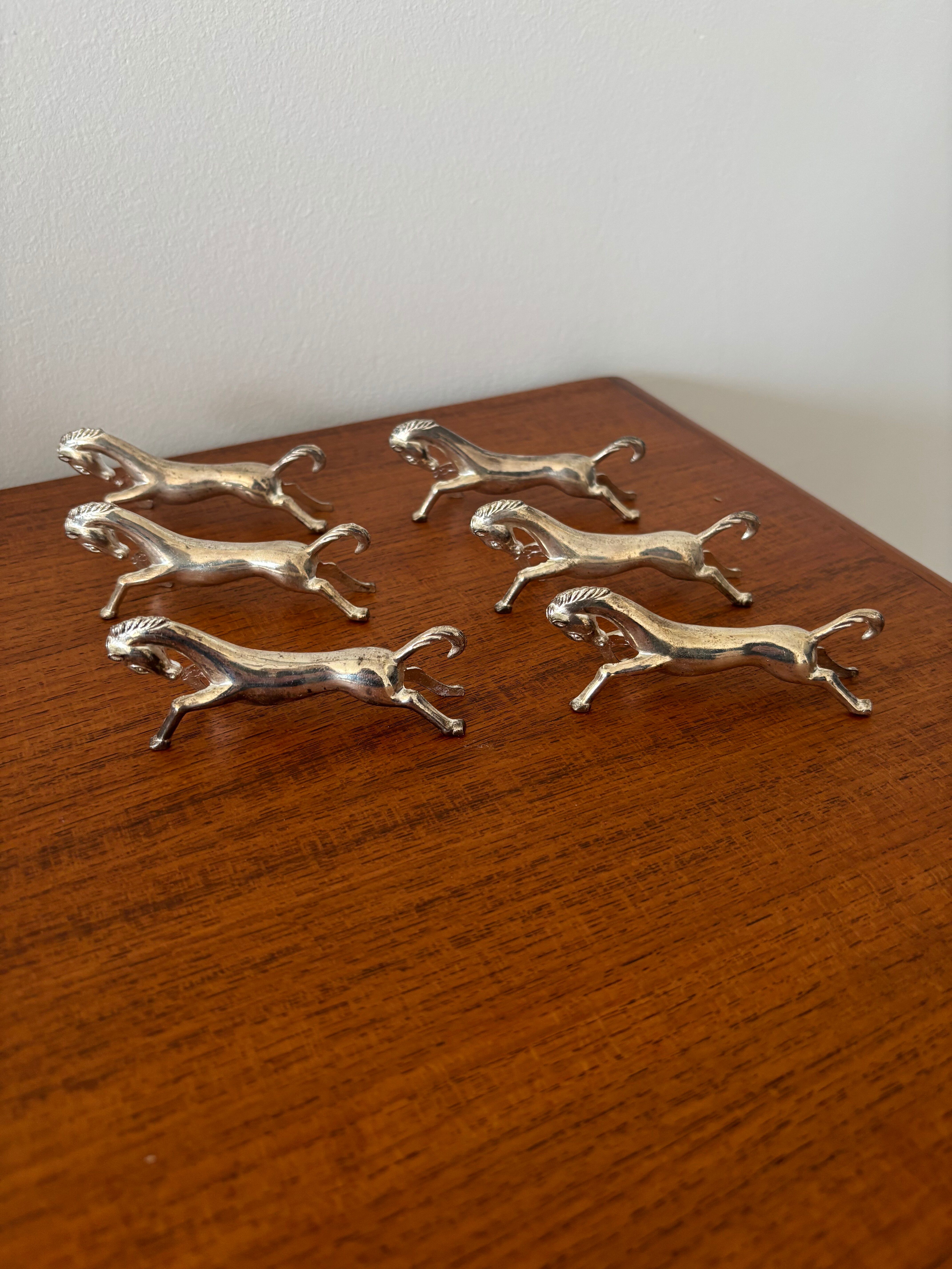 Set of 6 vintage galloping horse knife rests in silver-plated metal.