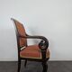 Restoration armchair in mahogany with cross arms and orange fabric.