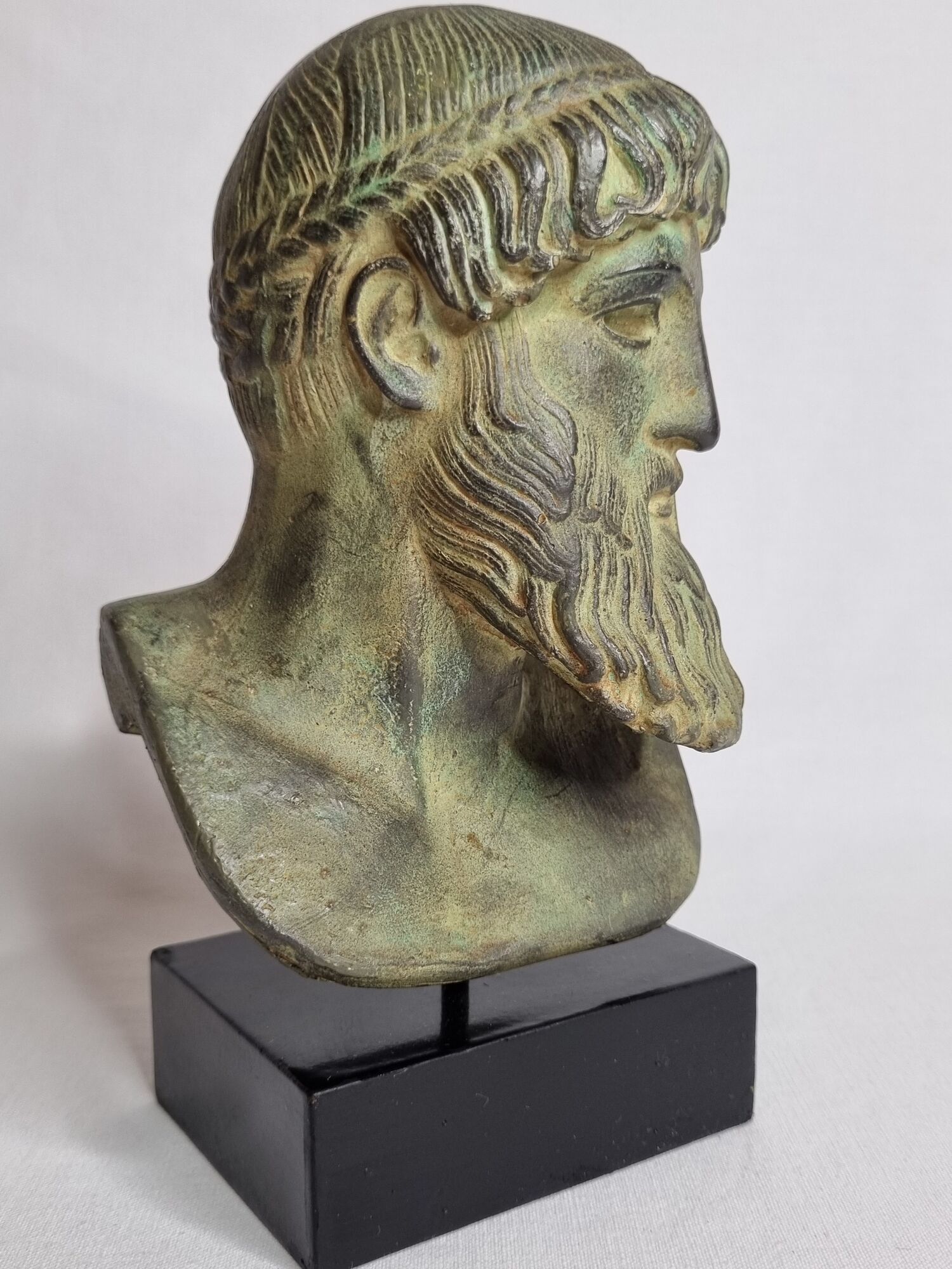 Bust of Poseidon in patinated plaster on wooden base