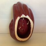 Empty pocket in the shape of a burgundy hand