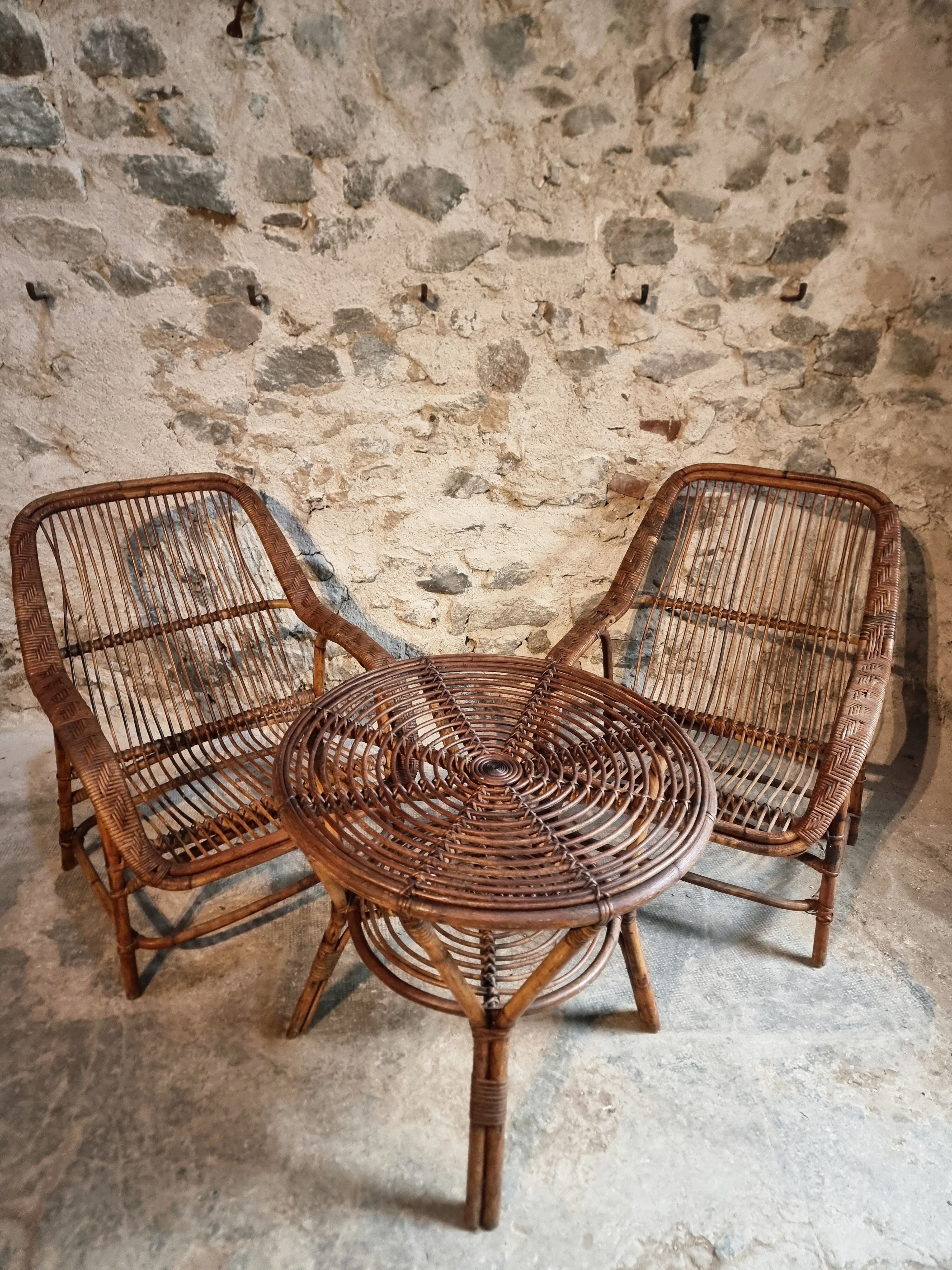 Vintage rattan lounge set, French wicker armchairs and round table, circa 1930–1950.