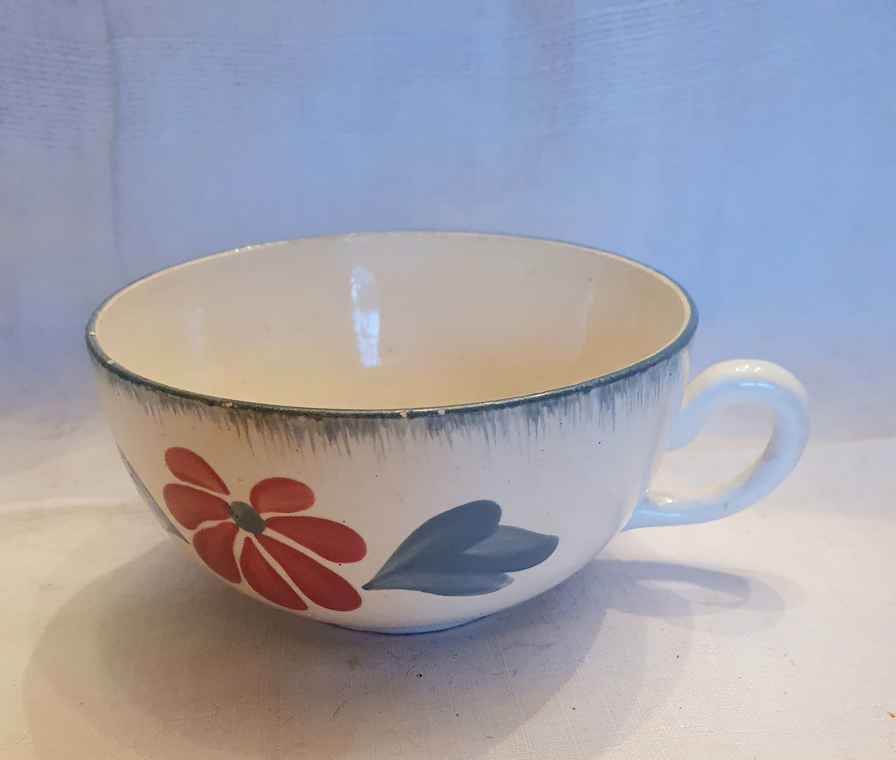 Old big cup in faience with flower decoration