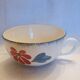 Old big cup in faience with flower decoration