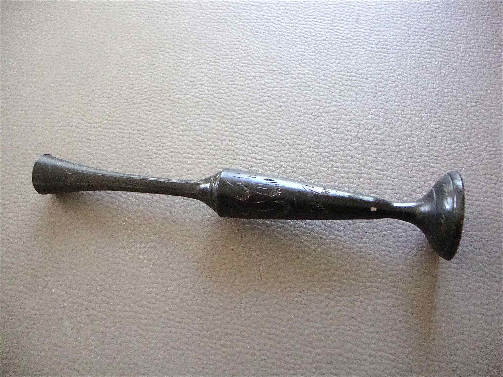 Stylized vase in engraved metal