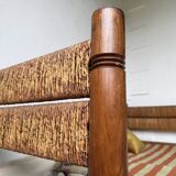 Brutalist style bed with chain and straw