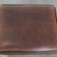 Sturdy vintage sheepskin ottoman in a beautiful large size with black piping