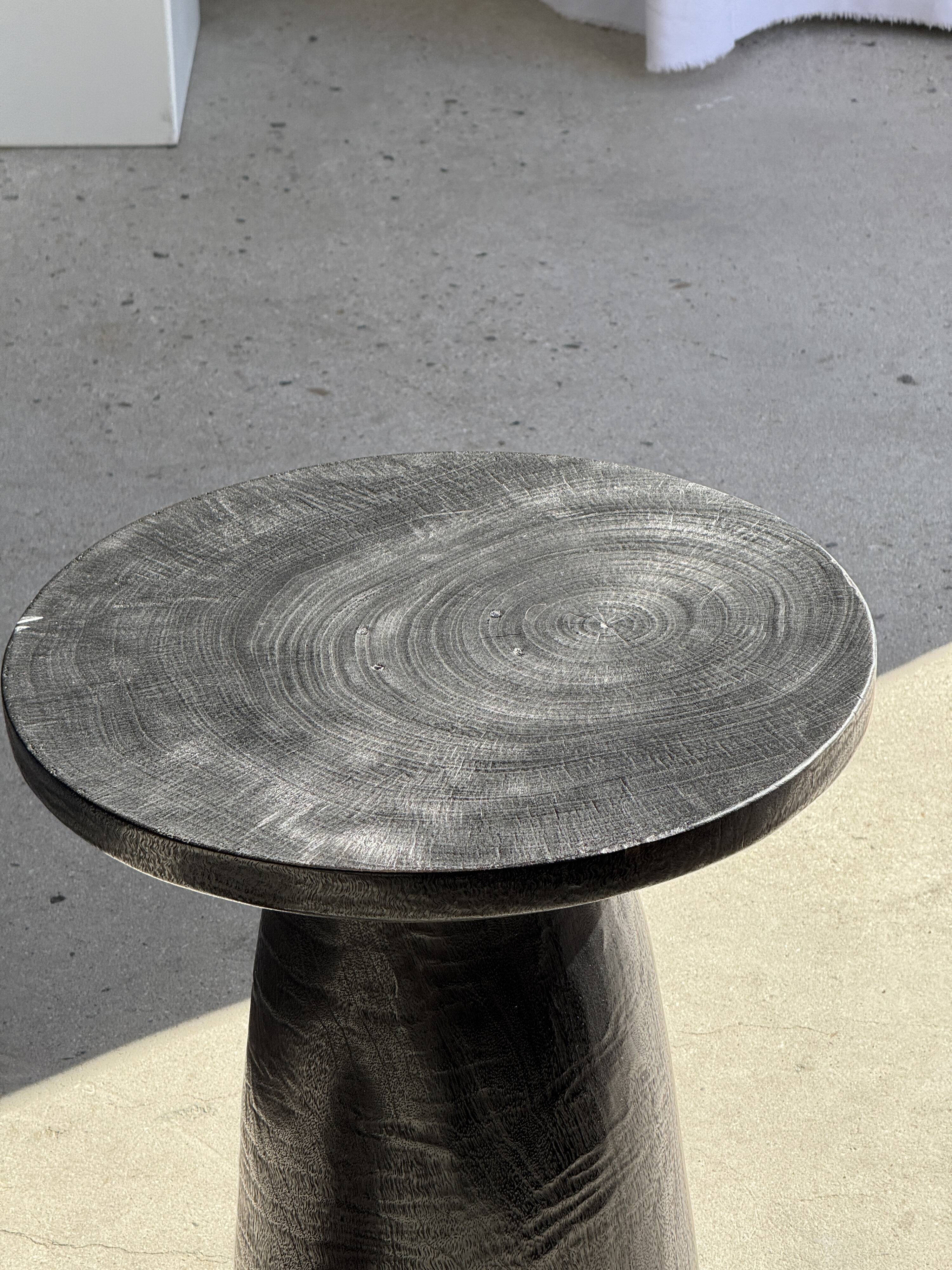 Black solid mango side table (monoxyle) with conical legs