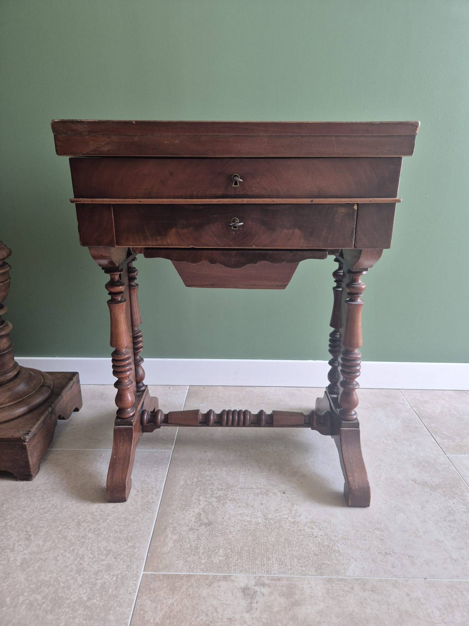 Antique wooden sewing cabinet with mirror and storage.