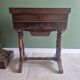 Antique wooden sewing cabinet with mirror and storage.