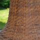Large wooden lamp with a woven rattan shade.