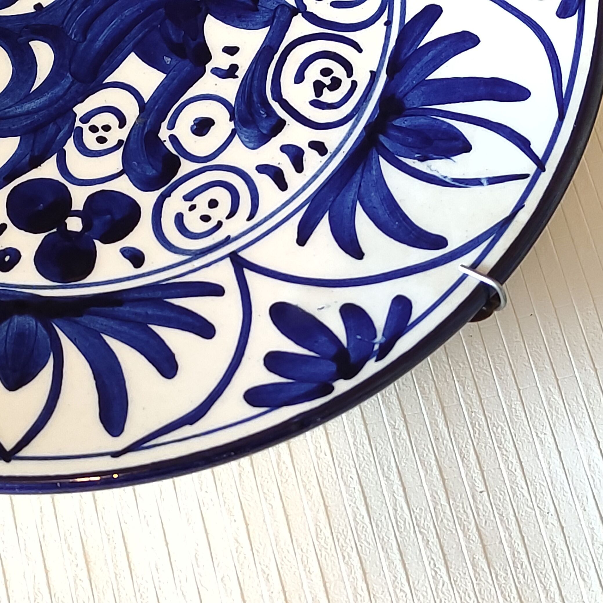 Hand-painted decorative plate decorated with a blue chimera pattern