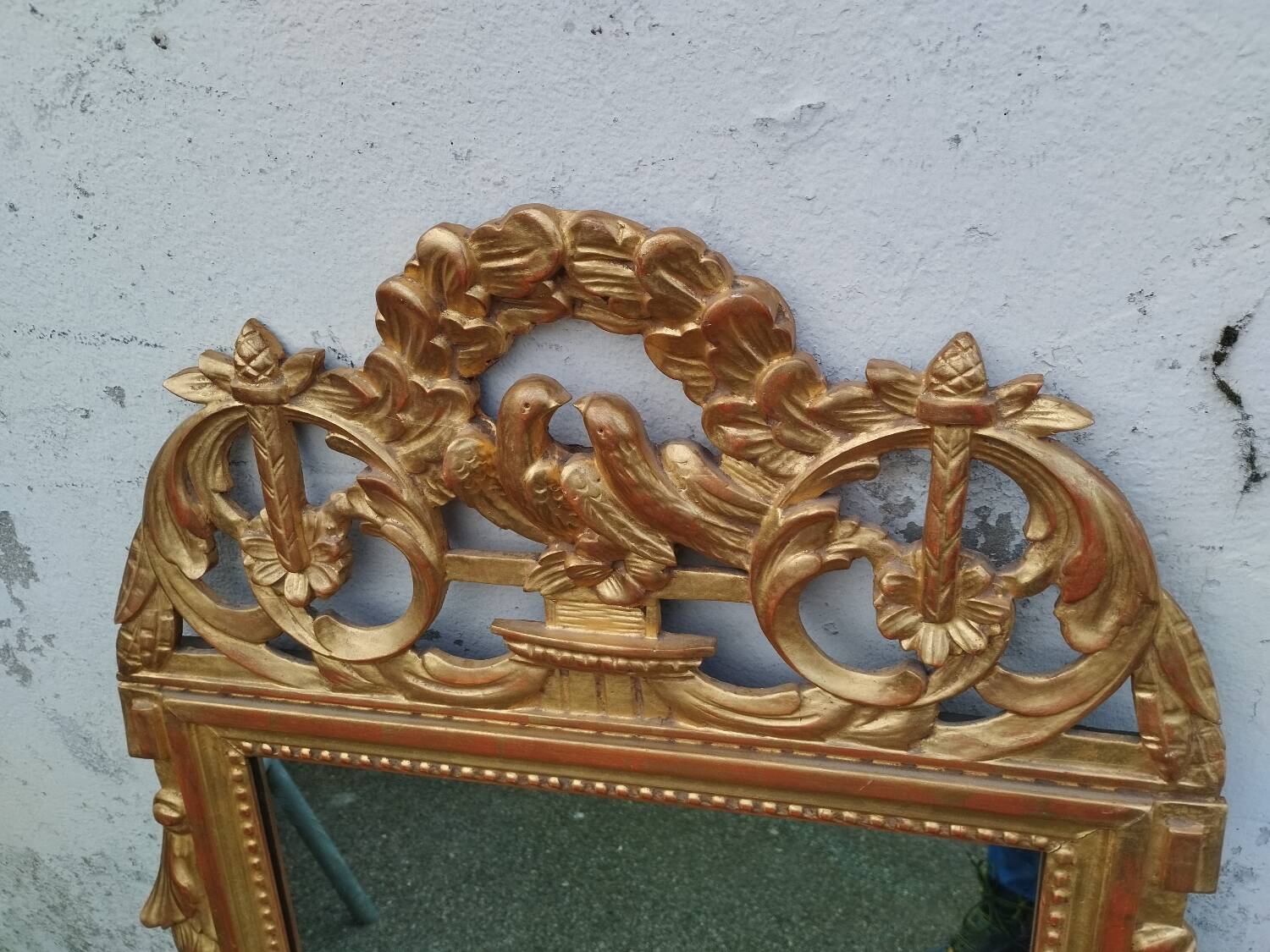 Antique gilded wooden mirror in Louis XVI style
