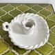 Hand-held candle holder with braided ceramic bowl