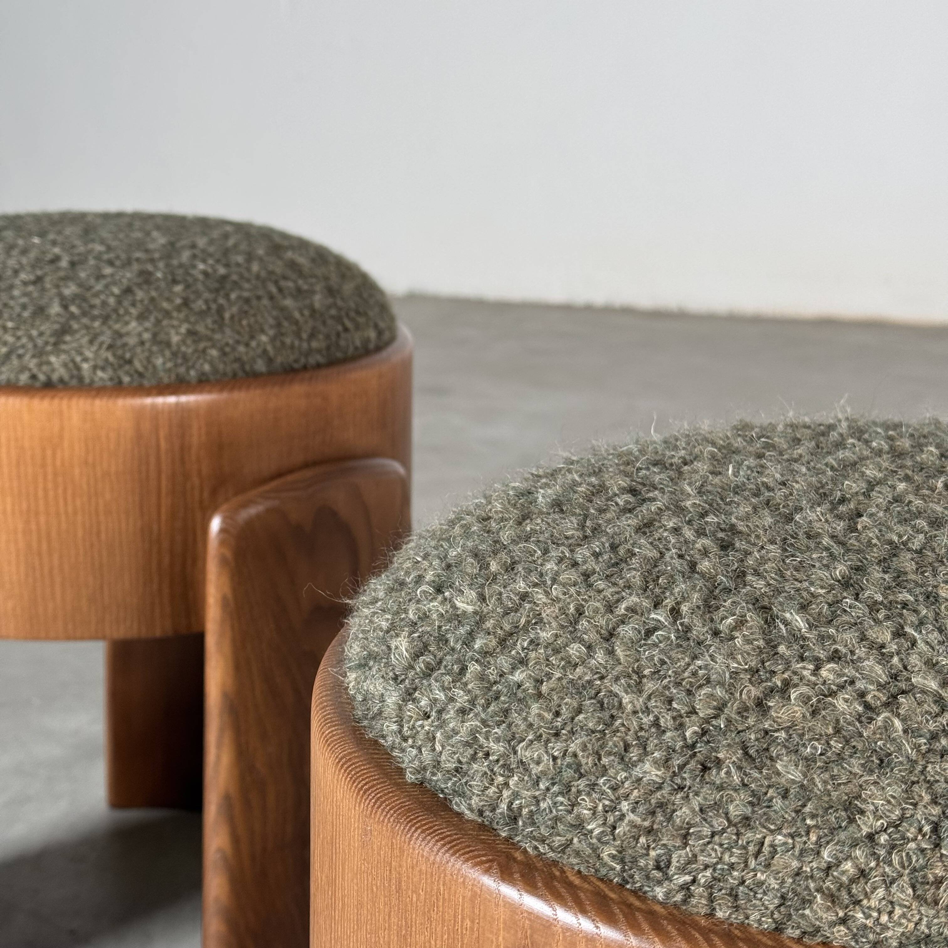 Sculptural pair of ash wood stools with dedar milano bouclé