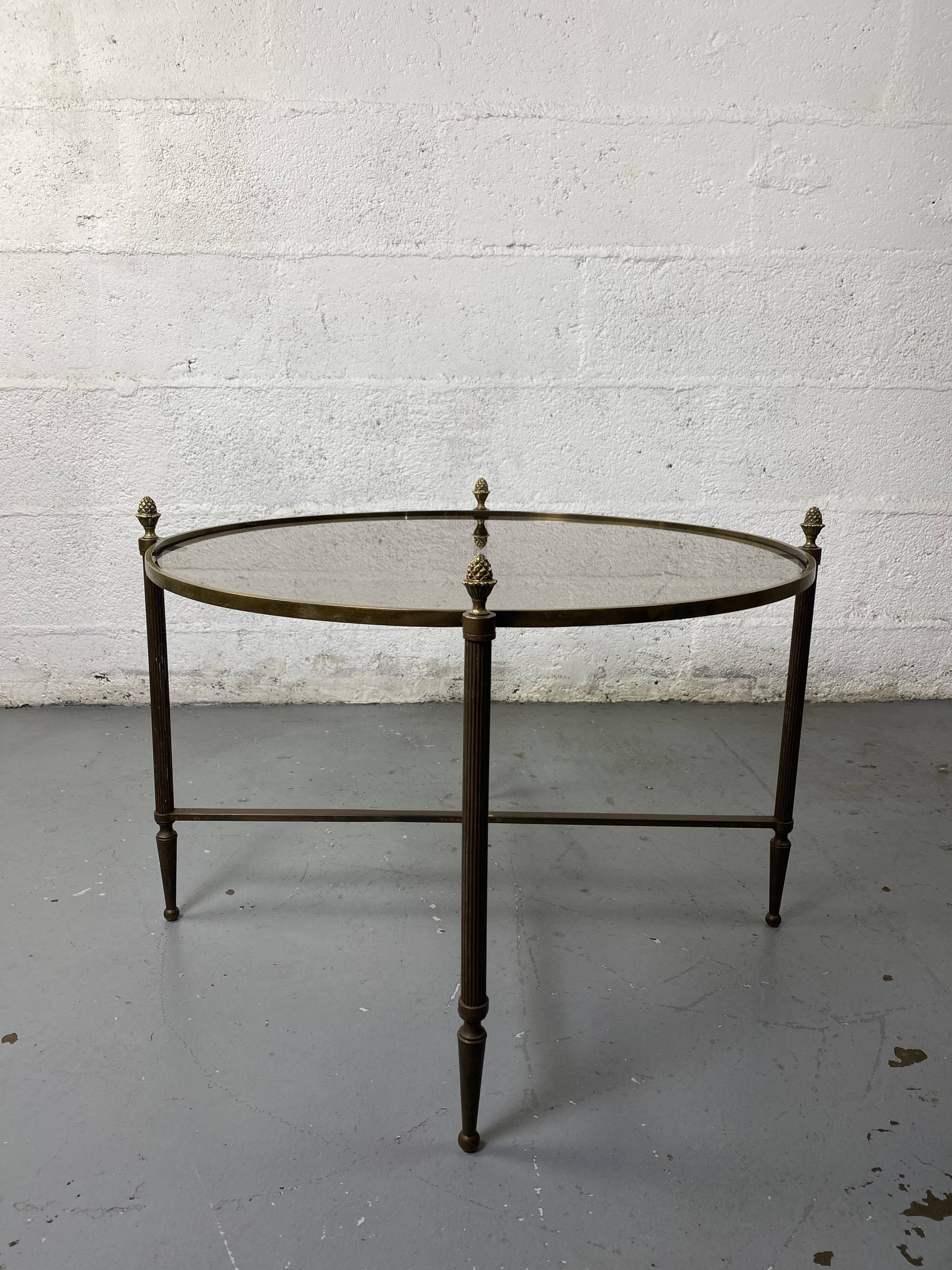 Round coffee table in brass and smoked glass
