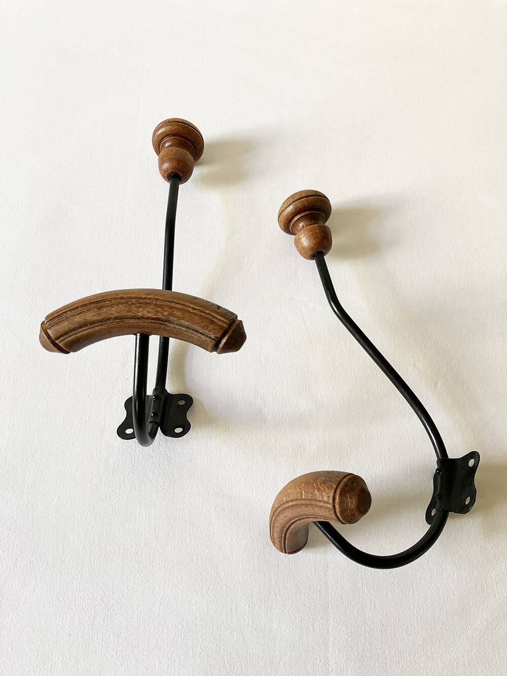 Pair of antique wooden and metal coat hooks