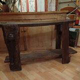 Small, very old, brutalist workbench equipped with a period workshop lamp