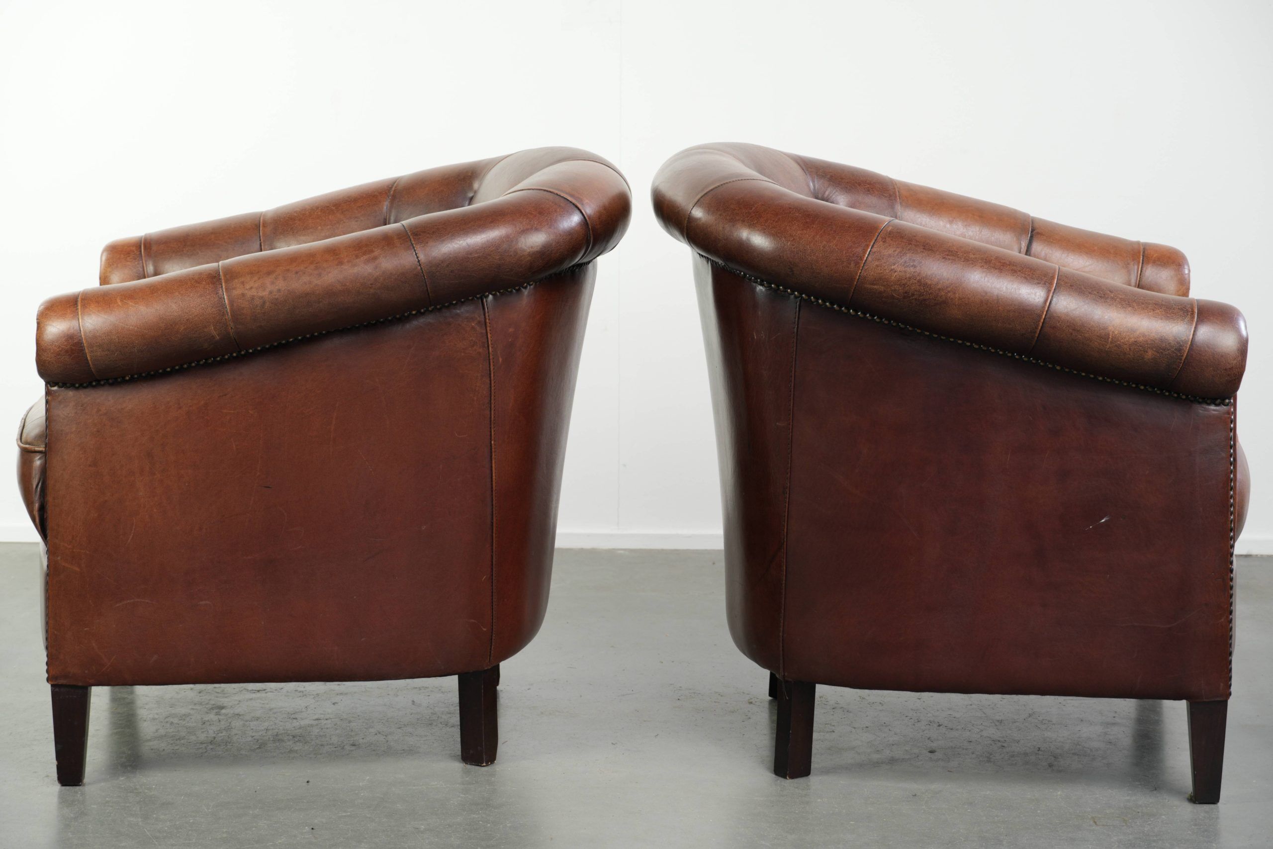 Characterful set of sheepskin club armchairs in English chesterfield style