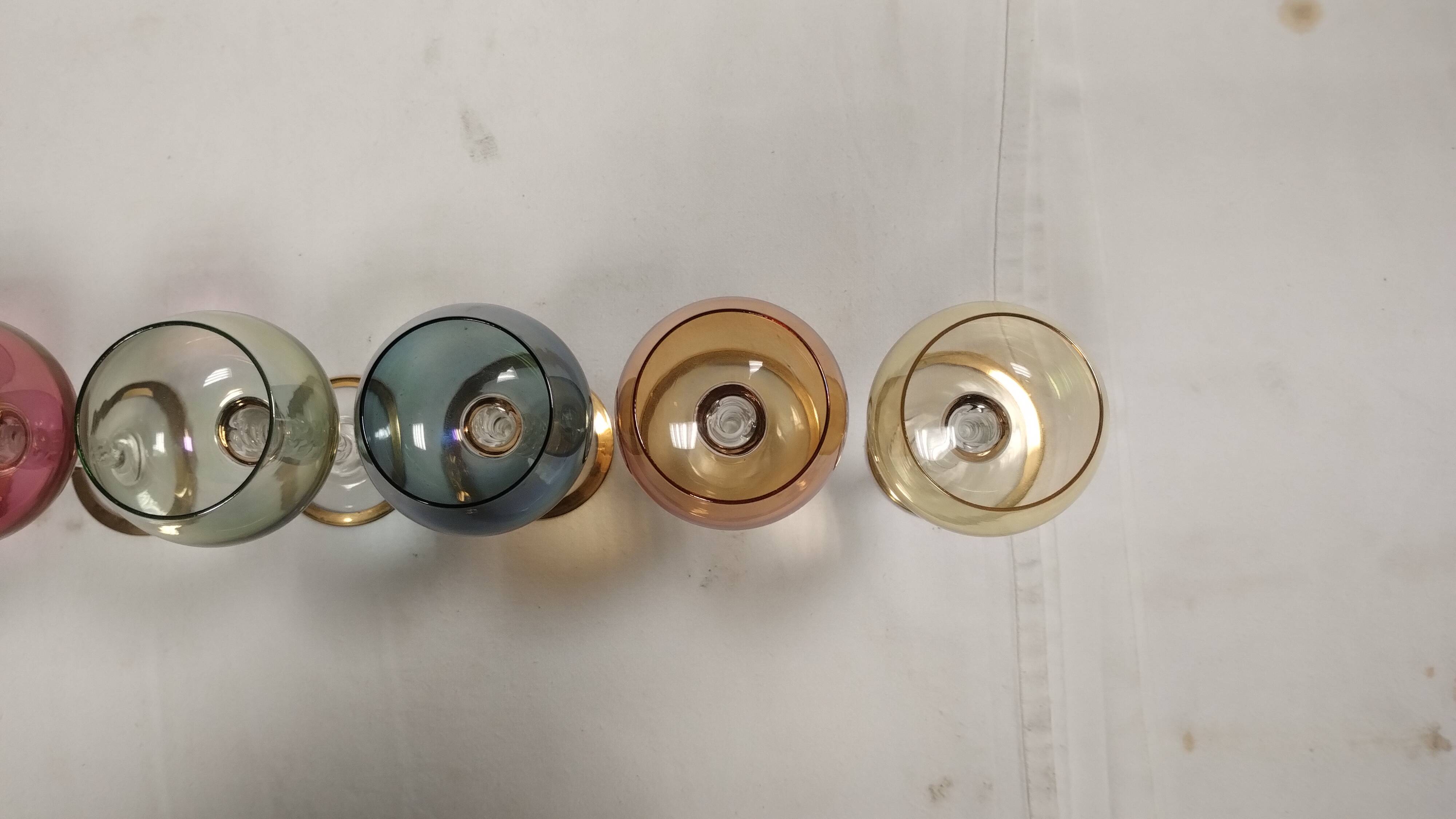 Set of 6 colored crystal stemmed glasses with gold twisted foot.