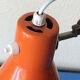 Luxo L9 orange single-arm lamp on plinth