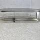 Coffee table with steel base and smoked glass slab. Circa 197