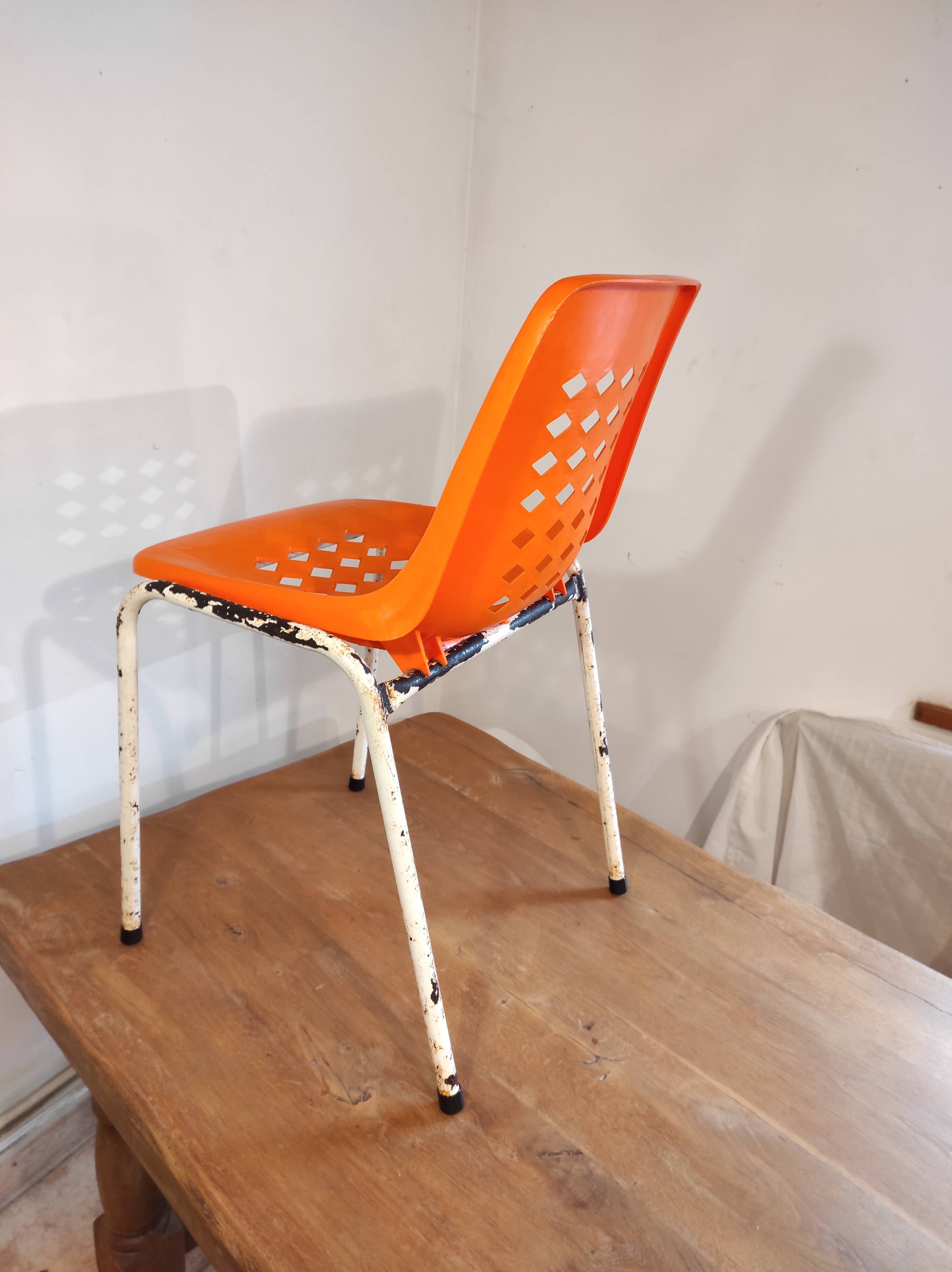 Chair with openwork plastic shell 1970