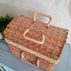 Small suitcase in vintage rattan trunk
