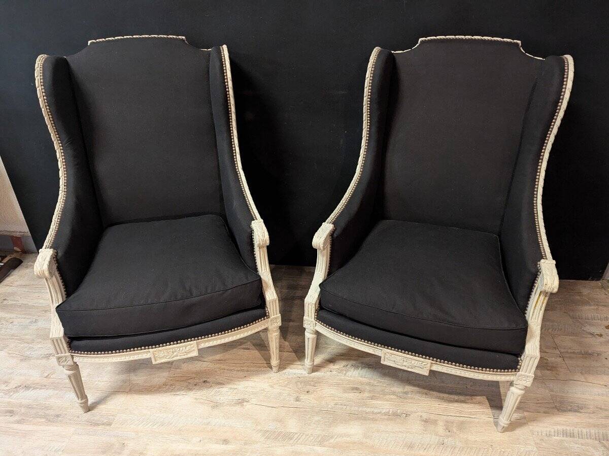 Pair of Louis XVI armchairs with ears in grey painted wood and black fabric.