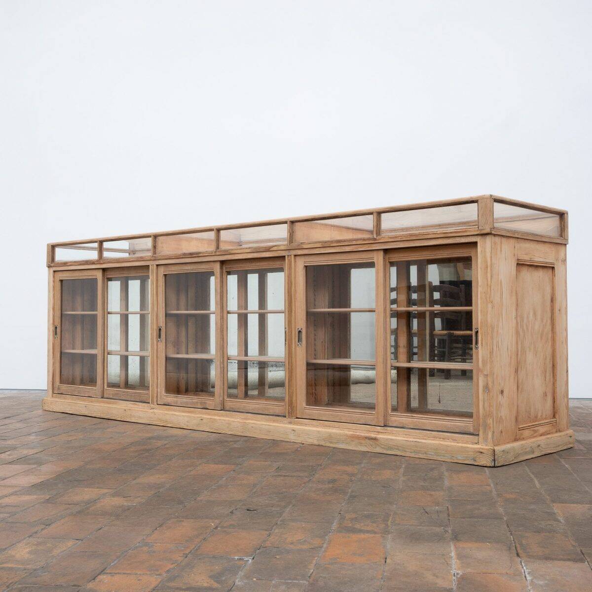 Old glass-fronted pine trade counter - early 20th century