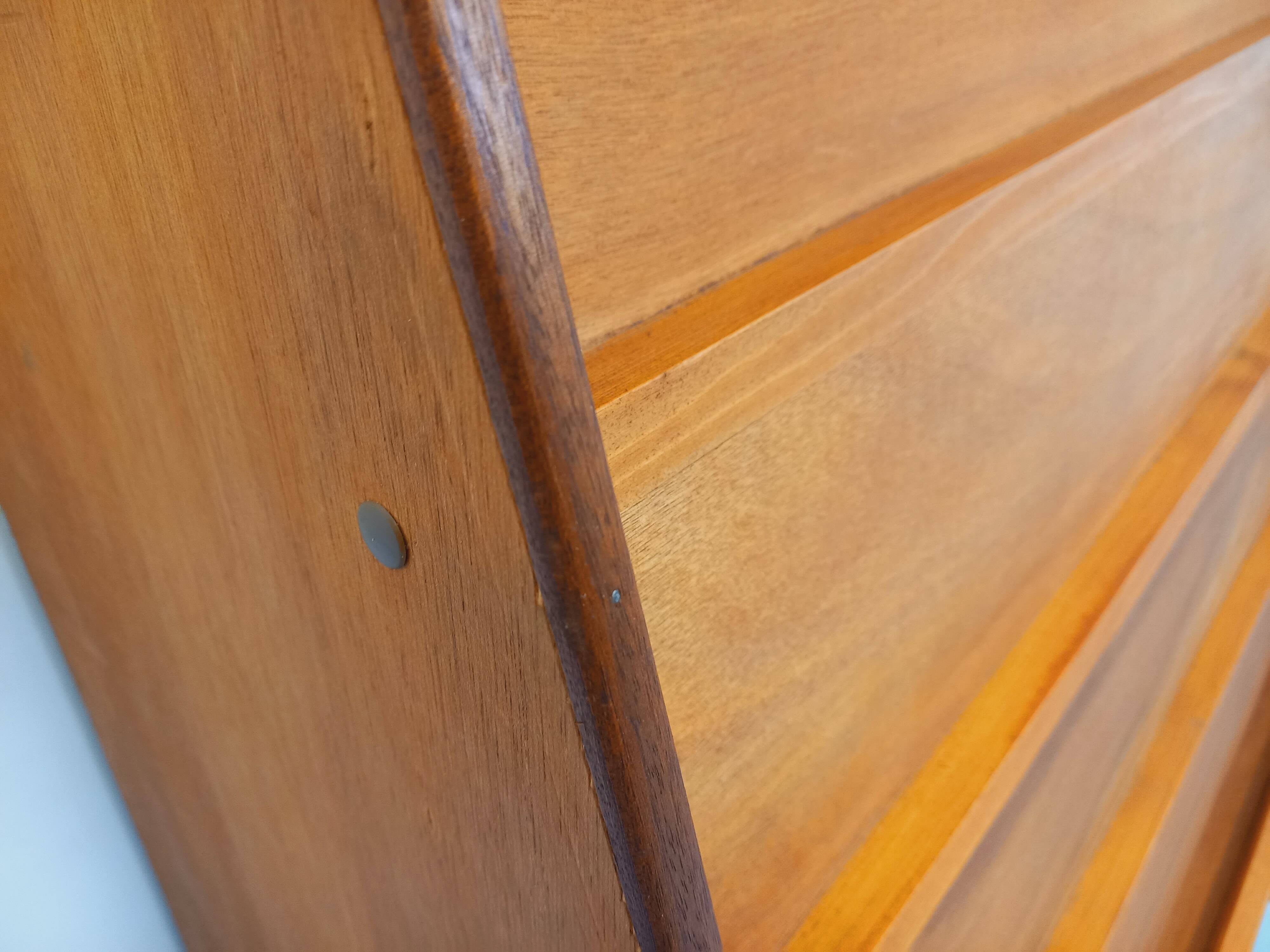 Vintage wooden display bookshelf with drawers from the 1960s.