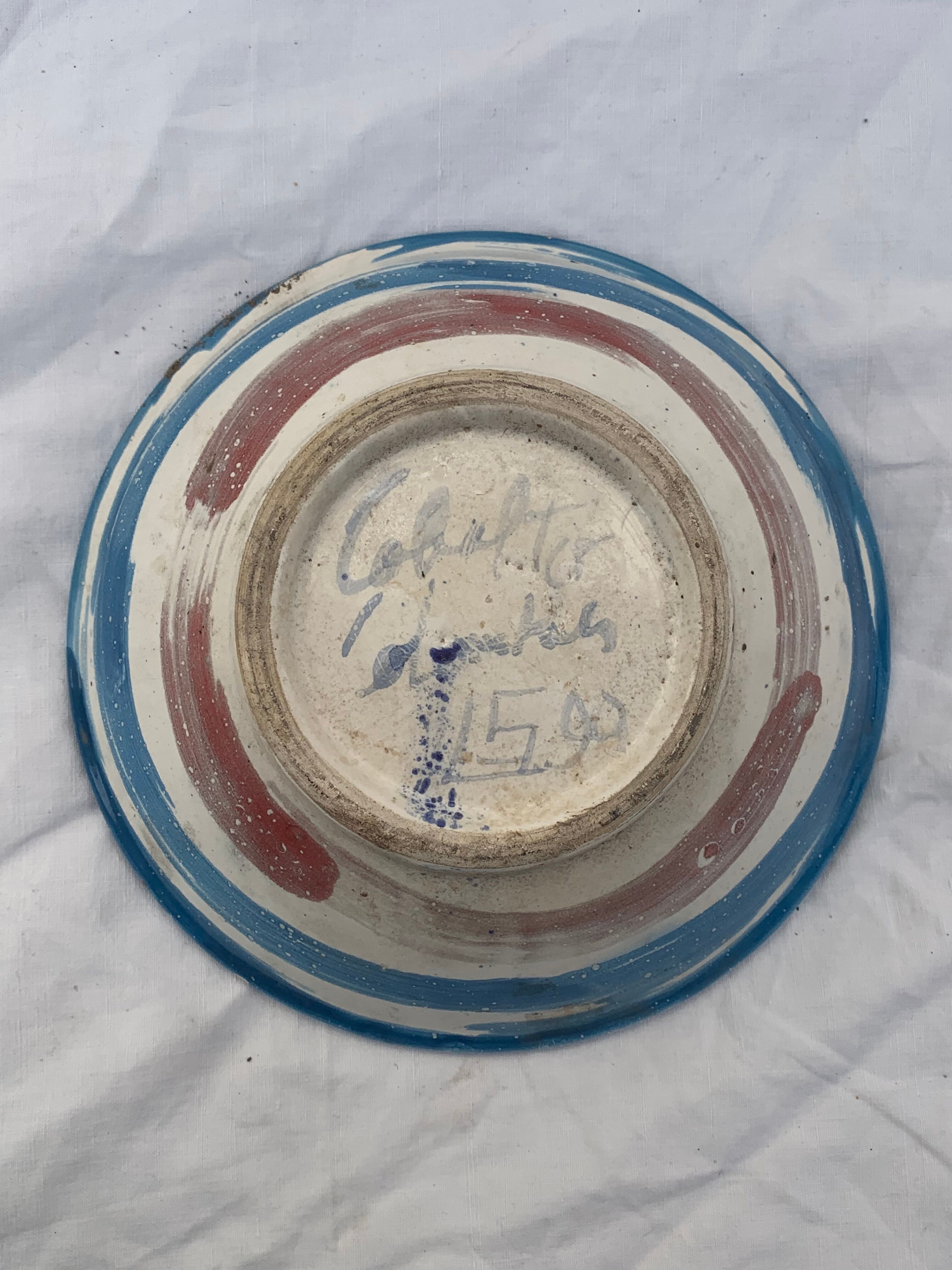 Hand-painted plate decorated with a colorful face 60s