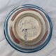 Hand-painted plate decorated with a colorful face 60s