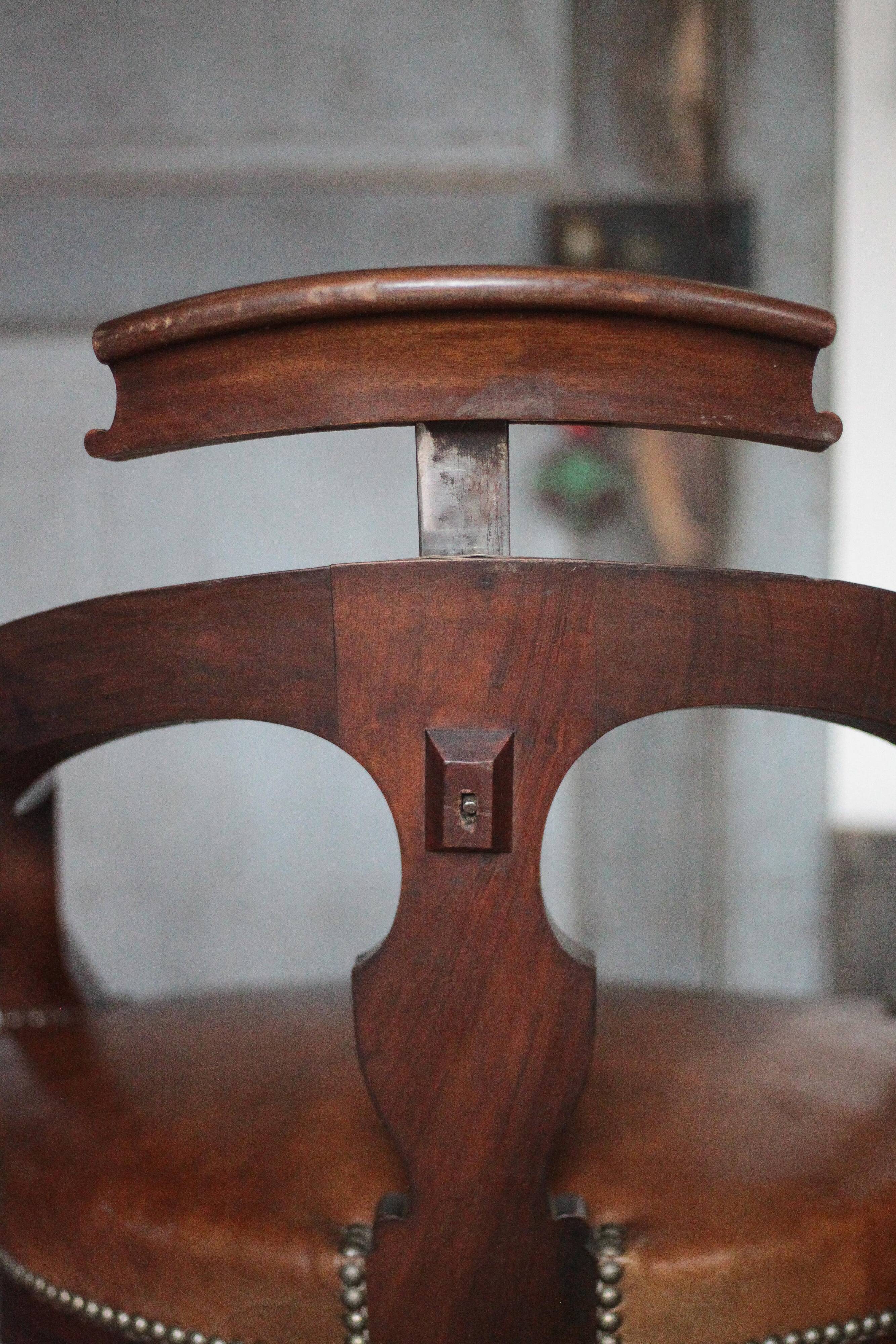 Barber chair in wood and leather with adjustable headrest, office chair.