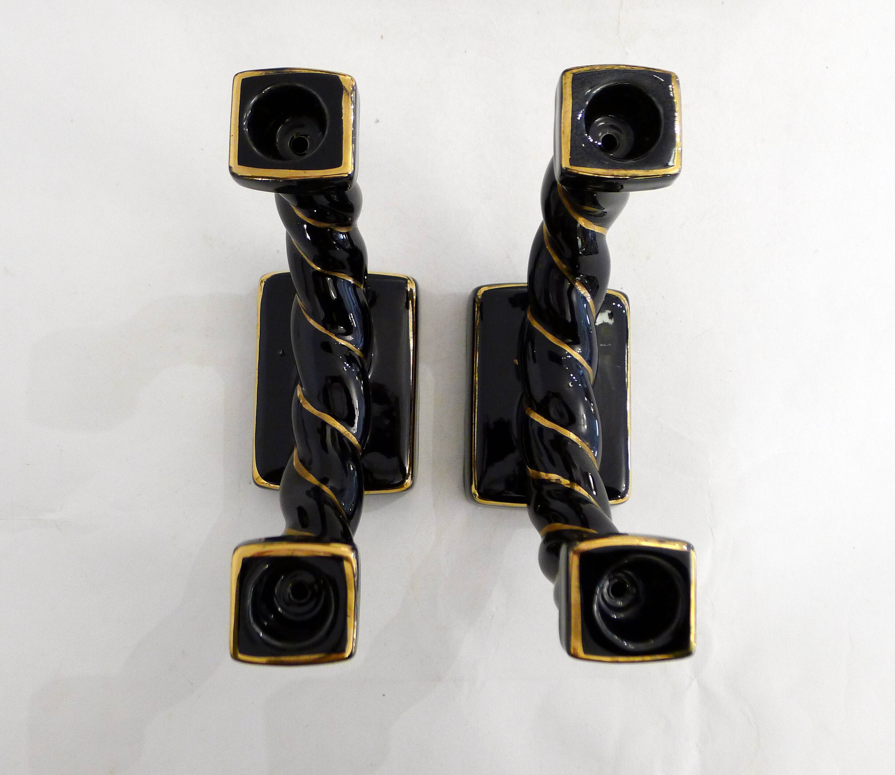 Pair of earthenware braided rope candlesticks