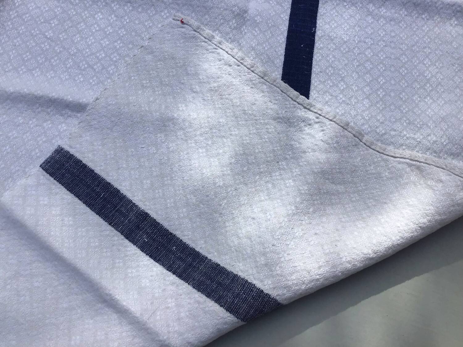 Old ecru Basque linen tea towel with navy blue stripes