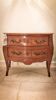 Louis XV style commode with two drawers and a pink marble top.