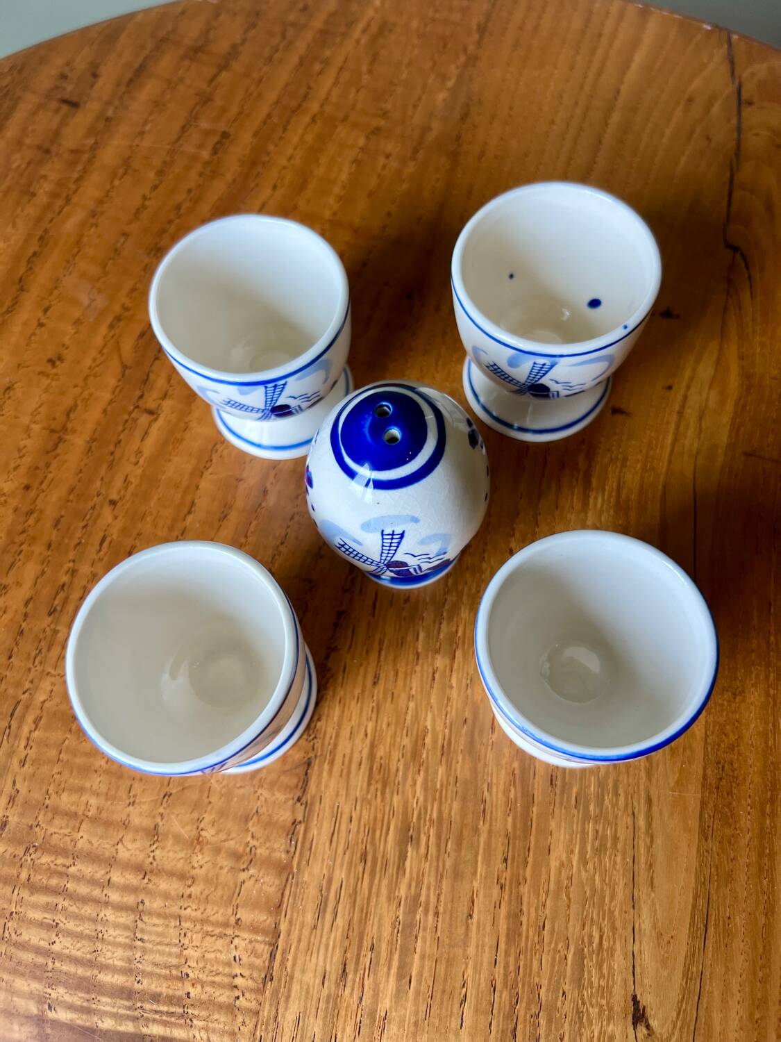 Set of 4 vintage egg cups and salt shaker in blue Delft pottery.