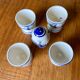 Set of 4 vintage egg cups and salt shaker in blue Delft pottery.