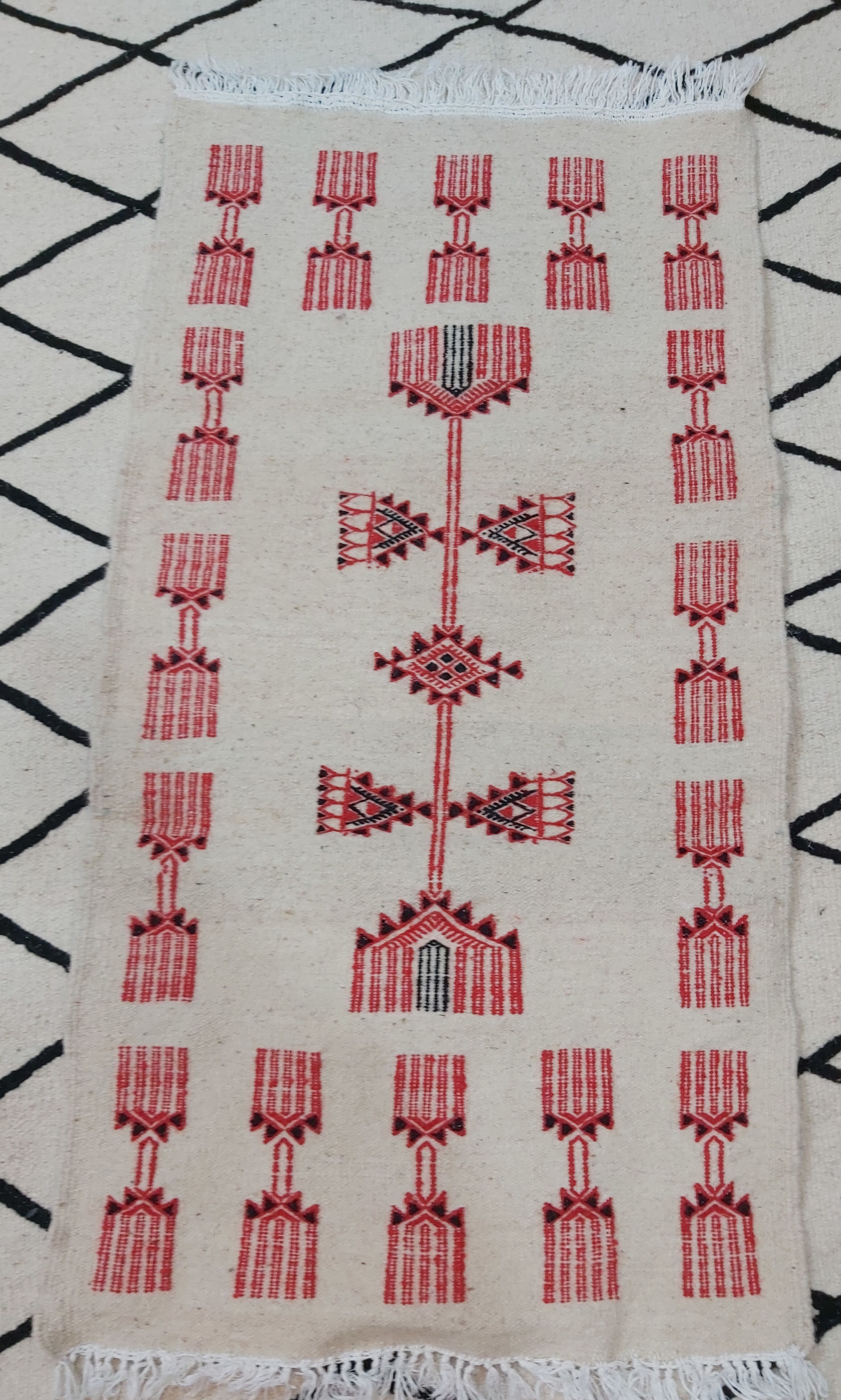 Traditional handmade white and red carpet