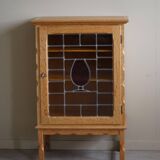 Scandinavian wardrobe in natural oak with a glass front.