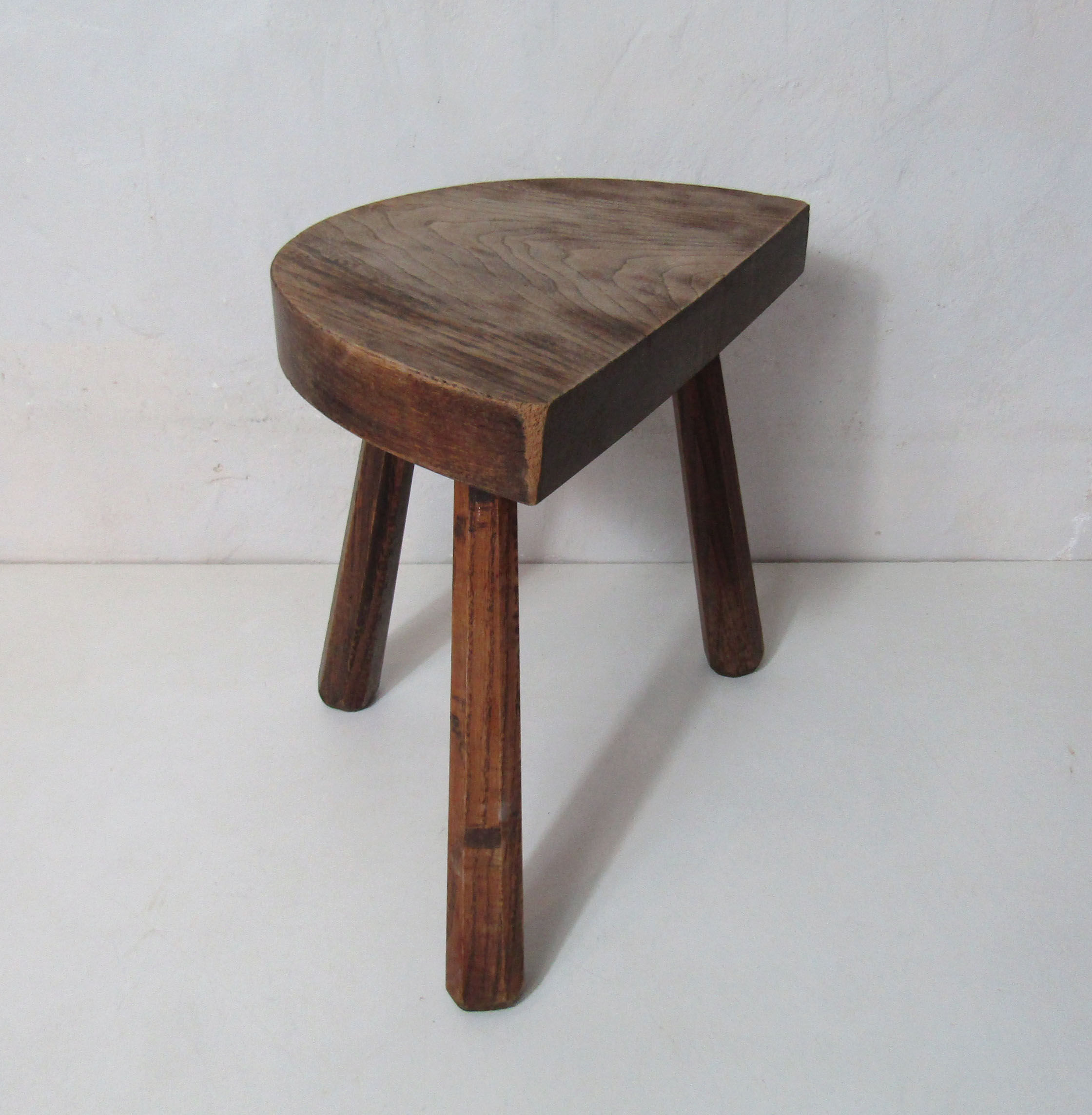 Old half-moon wooden tripod stool