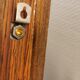 Wall light in rosewood with bobble glass ball shade.