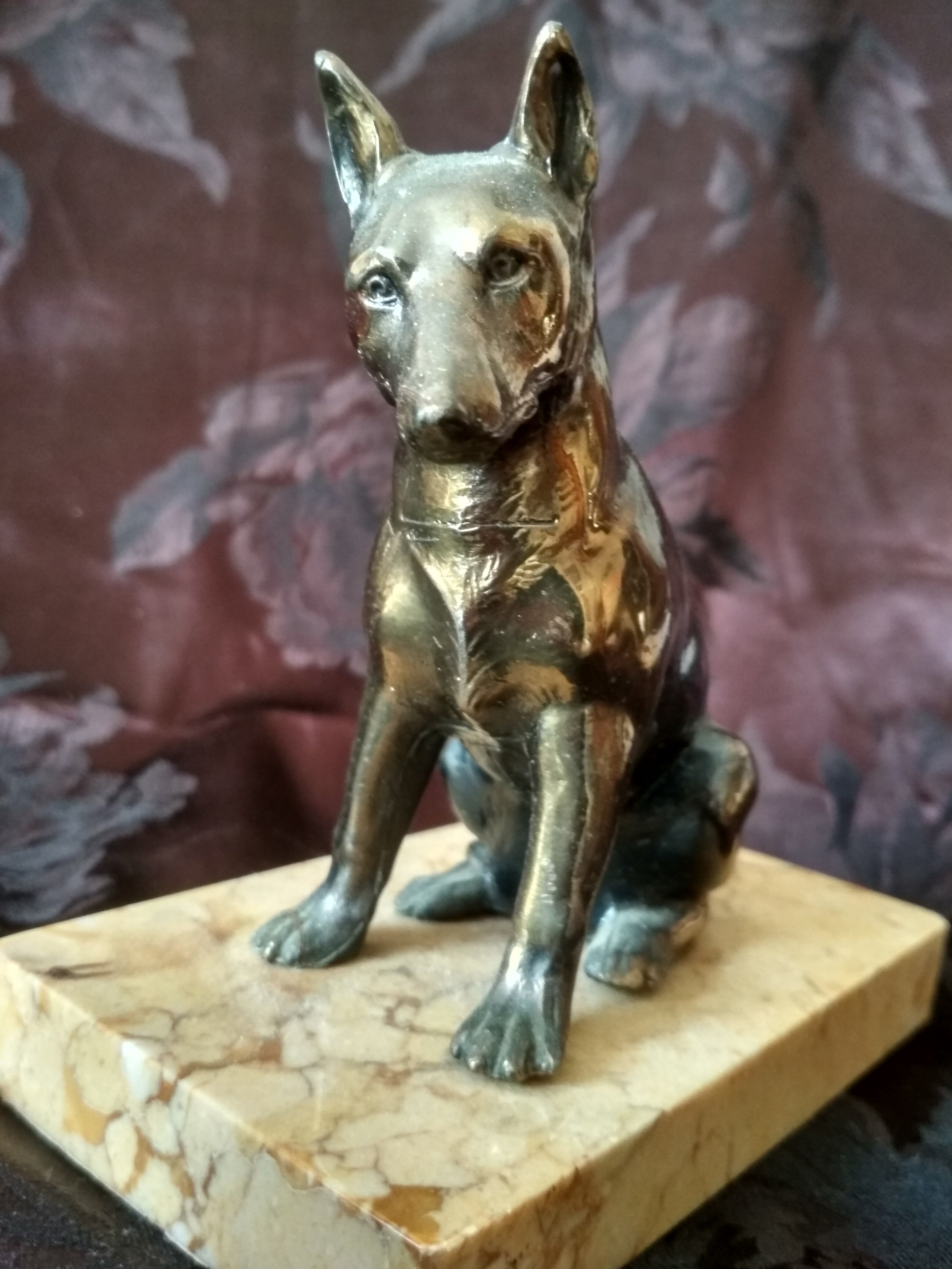 Greenhouse book dog sculpture regulates on marble slab
