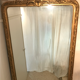 Large antique mirror with flagship shell in wood and gilded stucco